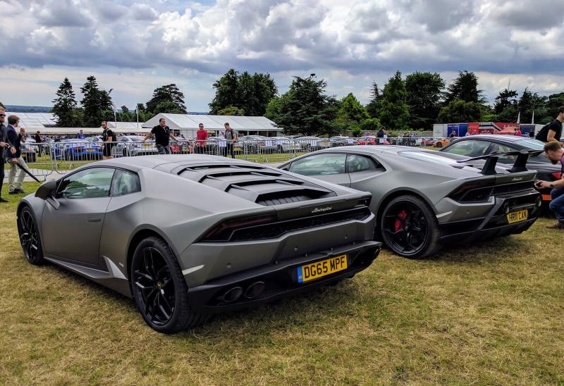 Two cars parked together in the exotics parking area at Goodwood