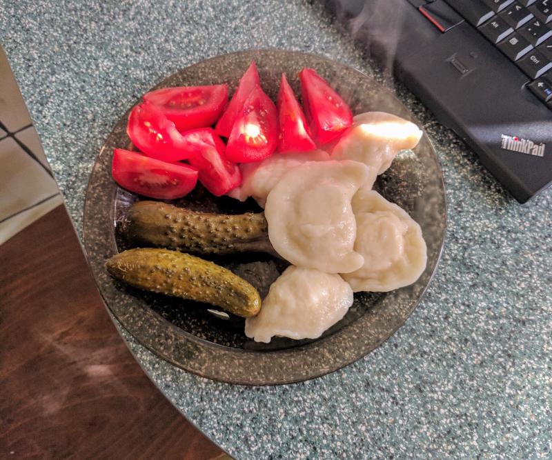 Pierogi, pickle, and tomato served in Krakow