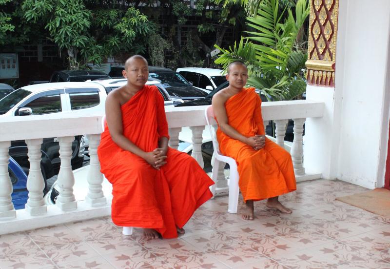 Monks in Wat Chai Pra kiat. These two gentlemen were slouching and lounging in the chairs. As I walked up, I asked if I could take a picture. They agreed and both straightened up and looked 'monkly'. I love this picture.